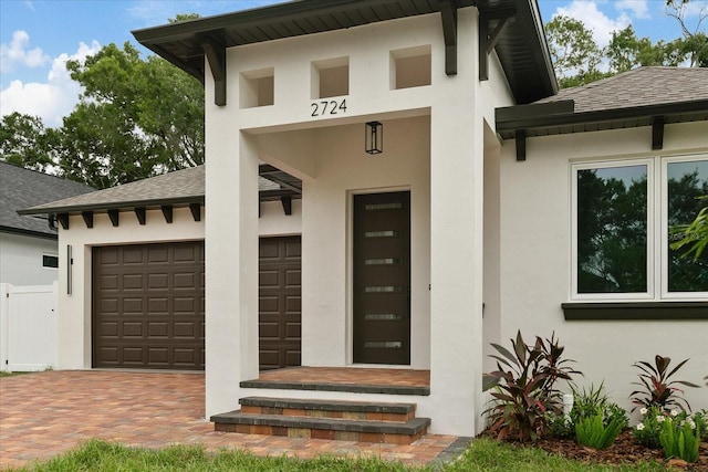 view of exterior entry featuring a garage