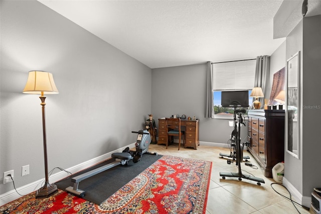 exercise room with light tile patterned flooring