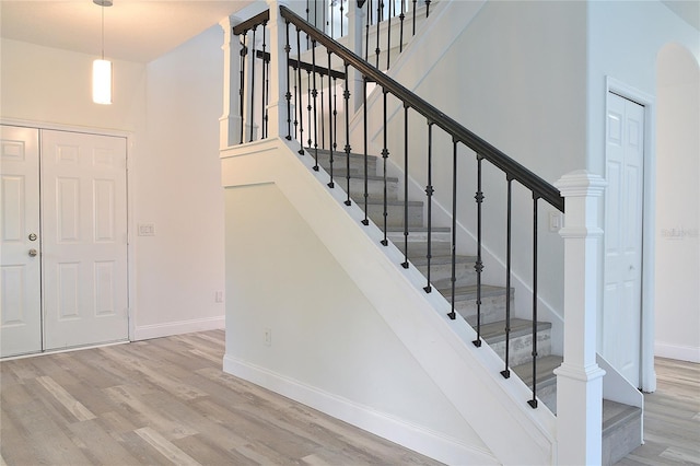 stairs with hardwood / wood-style flooring