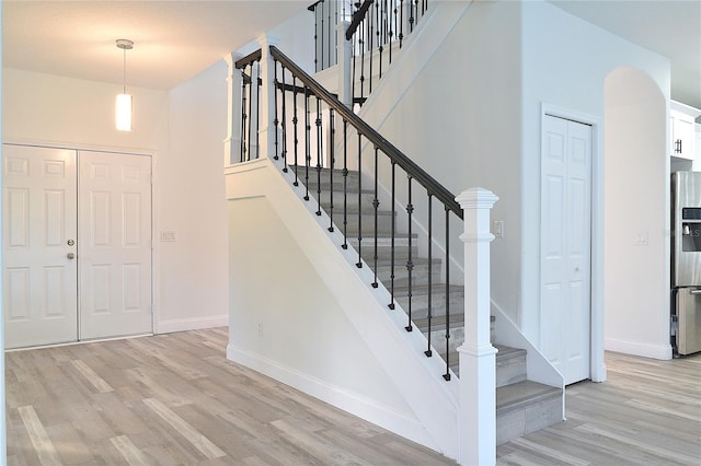 stairs featuring light hardwood / wood-style flooring