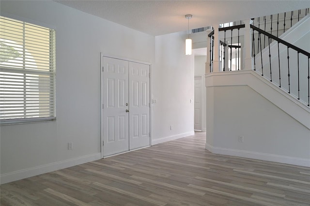 interior space featuring a textured ceiling and hardwood / wood-style floors