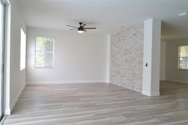 spare room featuring light hardwood / wood-style flooring and ceiling fan