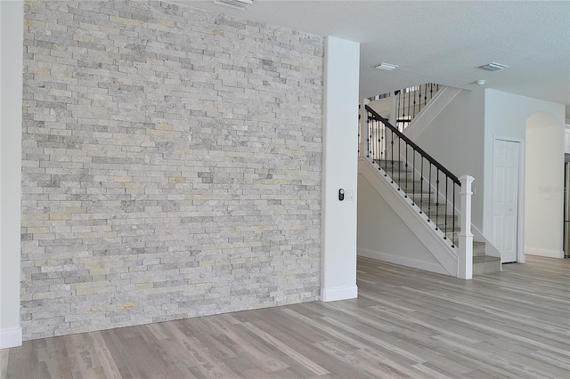 interior space featuring light hardwood / wood-style floors and a textured ceiling