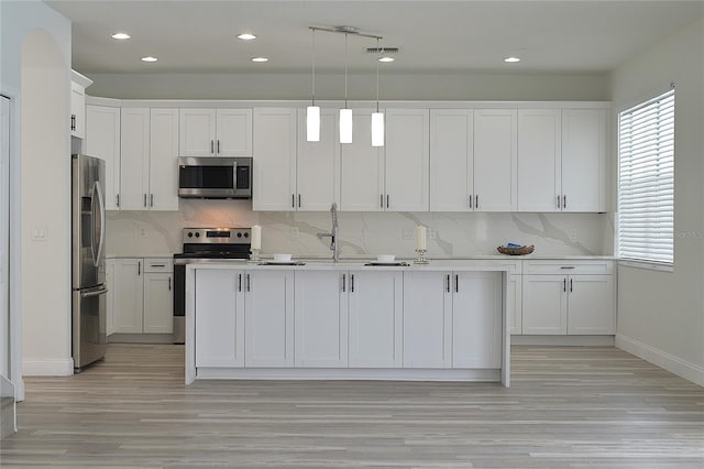 kitchen featuring light hardwood / wood-style floors, white cabinets, and stainless steel appliances