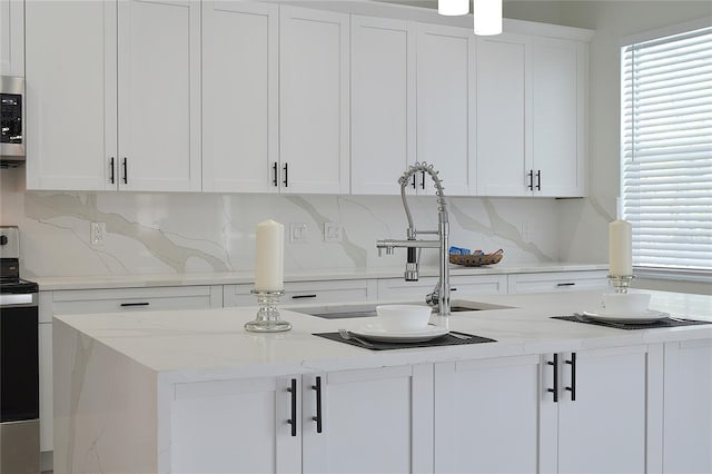 5308 Cedarshake Ln, Valrico, FL 33596 - kitchen with white cabinets, tasteful backsplash, stainless steel appliances, and a sink