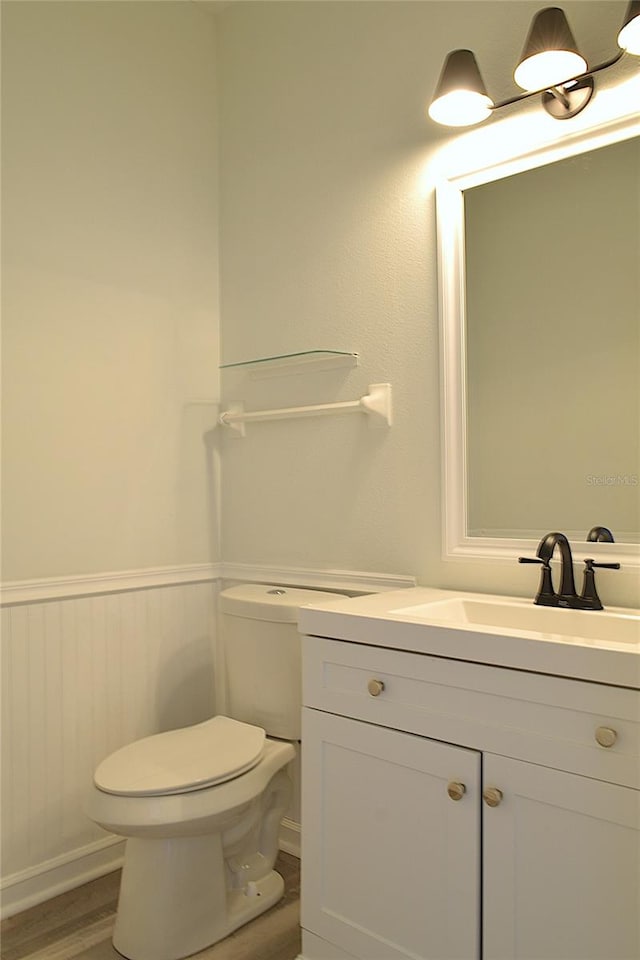 bathroom featuring hardwood / wood-style floors, vanity, and toilet