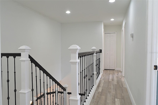 5308 Cedarshake Ln, Valrico, FL 33596 - corridor featuring baseboards, an upstairs landing, light wood finished floors, and recessed lighting