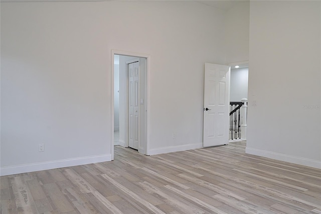 5308 Cedarshake Ln, Valrico, FL 33596 - unfurnished room featuring a towering ceiling, light wood-style floors, and baseboards