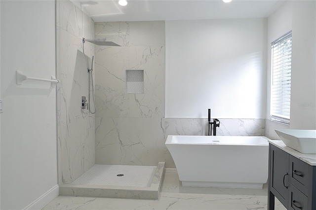 bathroom featuring tile patterned flooring, vanity, and a tile shower