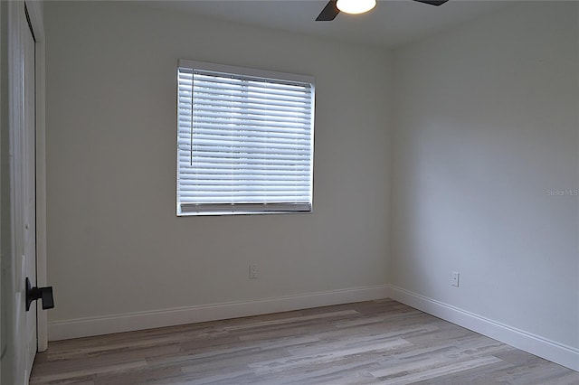 spare room with plenty of natural light, light wood-type flooring, and ceiling fan