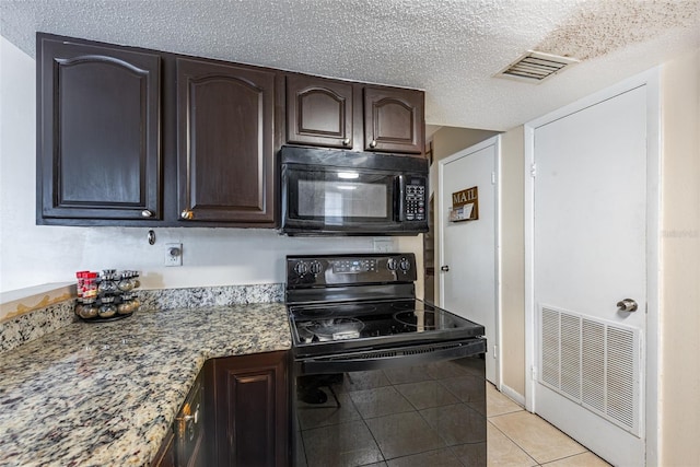 kitchen with light tile patterned flooring, black appliances, a textured ceiling, and dark brown cabinetry