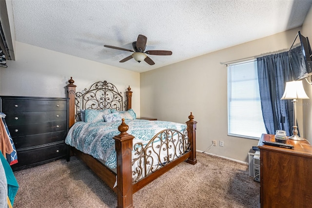 carpeted bedroom featuring multiple windows, a textured ceiling, and ceiling fan