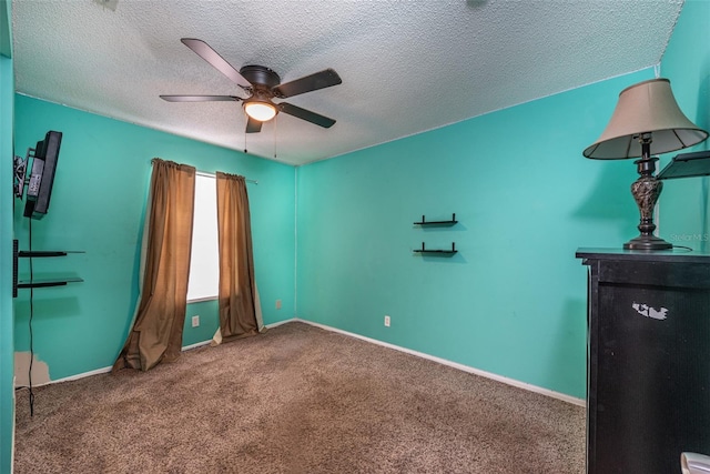 unfurnished bedroom with ceiling fan, carpet, and a textured ceiling