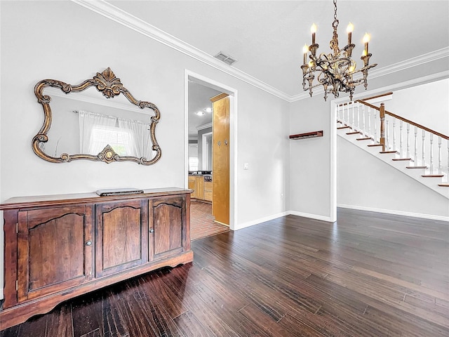 interior space with crown molding, dark wood-type flooring, and an inviting chandelier