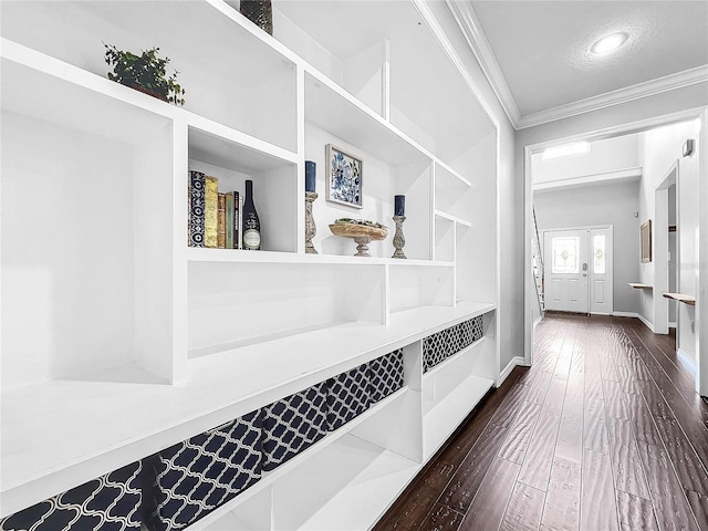 interior space featuring dark wood-type flooring, ornamental molding, and built in features