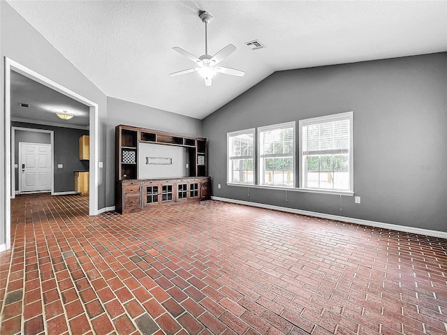 unfurnished living room with lofted ceiling, a textured ceiling, and ceiling fan