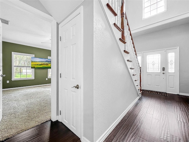 entrance foyer with vaulted ceiling and dark hardwood / wood-style flooring