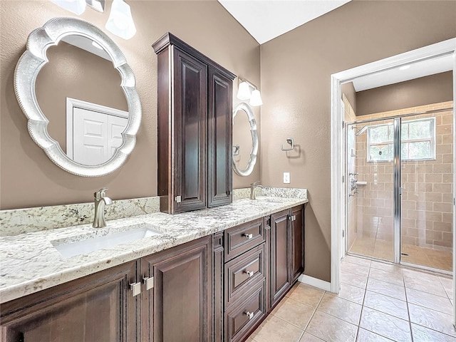 bathroom featuring vanity, an enclosed shower, and tile patterned floors