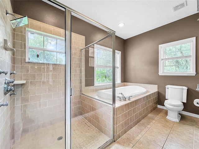 bathroom with tile patterned flooring, independent shower and bath, and toilet