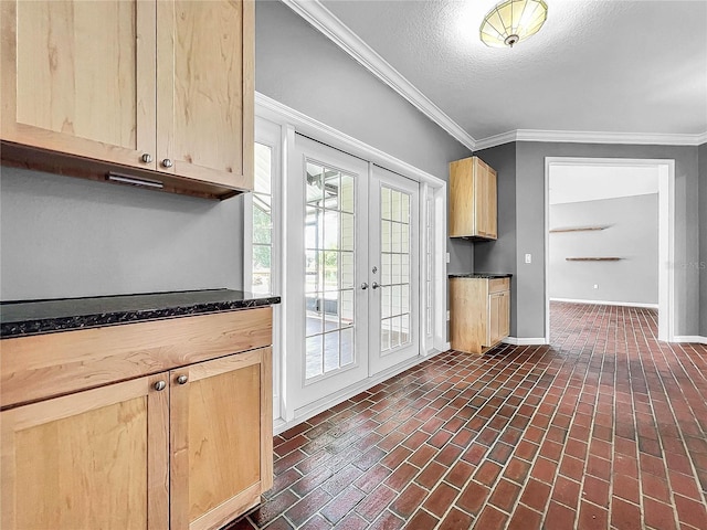 kitchen featuring crown molding, french doors, a textured ceiling, and light brown cabinets