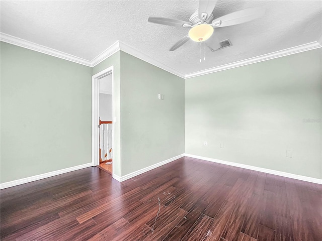 spare room featuring dark wood-type flooring, ceiling fan, ornamental molding, and a textured ceiling