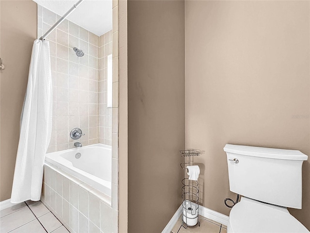 bathroom with tile patterned flooring, shower / tub combo, and toilet