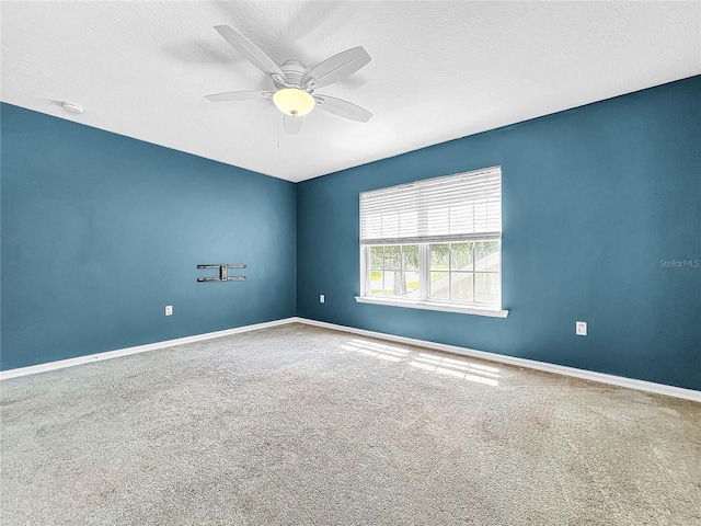 carpeted empty room featuring a textured ceiling and ceiling fan