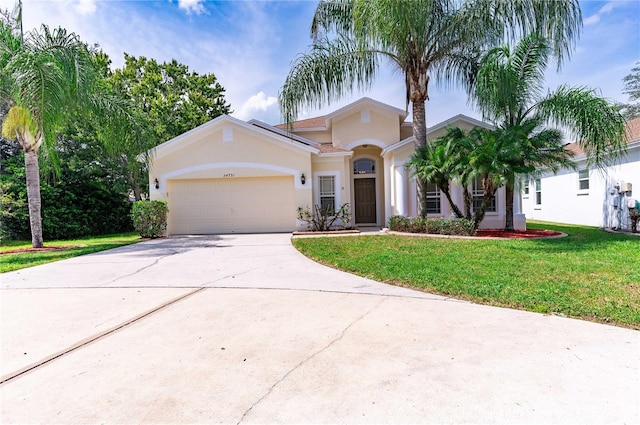 view of front facade with a front yard and a garage