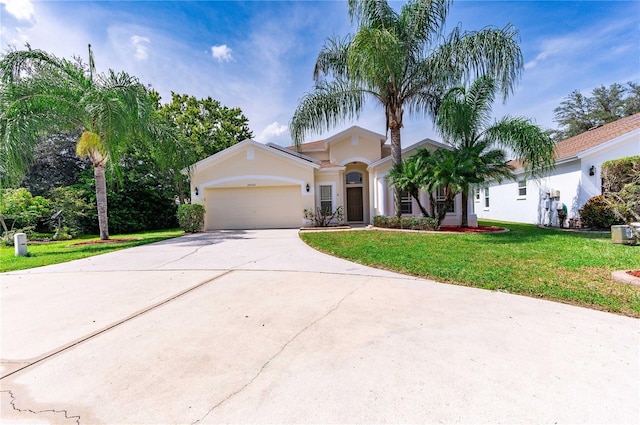 view of front of house featuring a garage and a front lawn