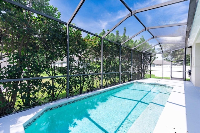 view of swimming pool with a lanai and a patio area