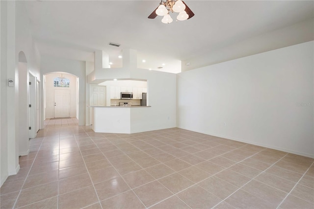 unfurnished living room with ceiling fan and light tile patterned floors