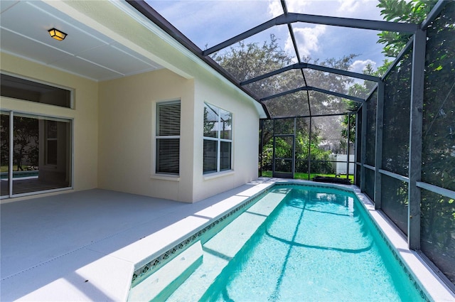 view of swimming pool with a patio area and a lanai