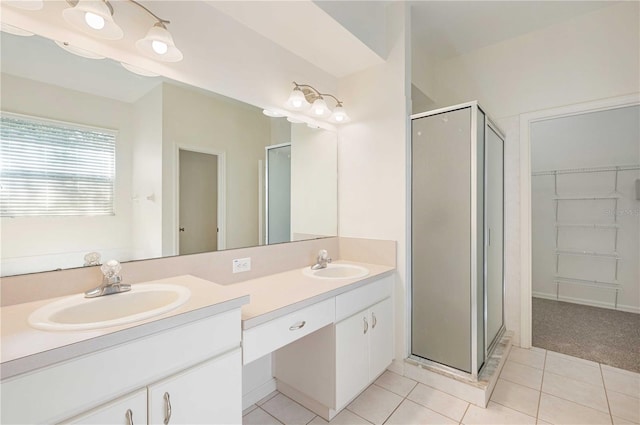 bathroom featuring a shower with door, tile patterned floors, and vanity