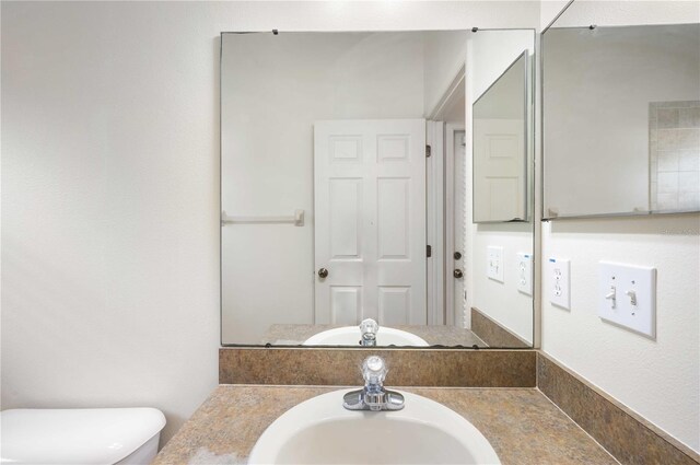 bathroom featuring vanity and toilet