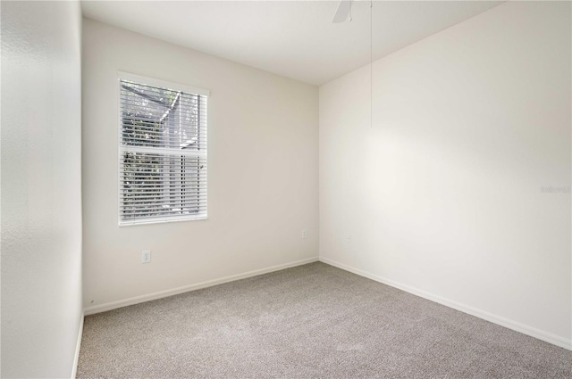 empty room with ceiling fan and carpet