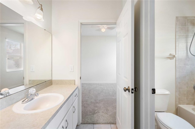 full bathroom with washtub / shower combination, toilet, tile patterned floors, and vanity