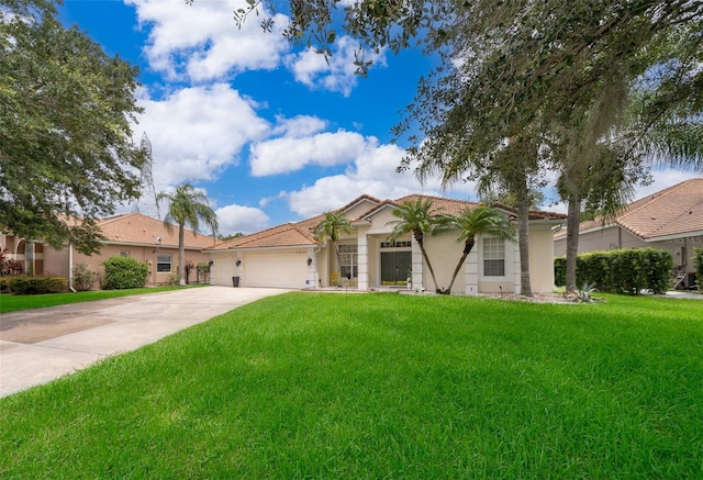 view of front of property with a garage and a front lawn