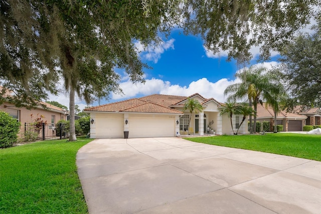 mediterranean / spanish house with a garage and a front yard