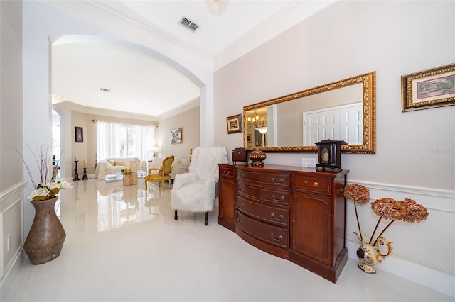 sitting room featuring ornamental molding and light tile patterned floors