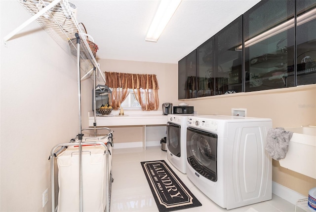 laundry room featuring cabinets and washing machine and dryer