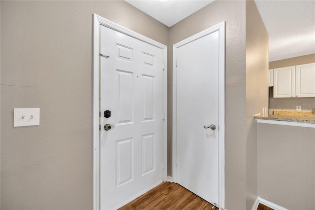 doorway to outside featuring hardwood / wood-style floors and a textured ceiling