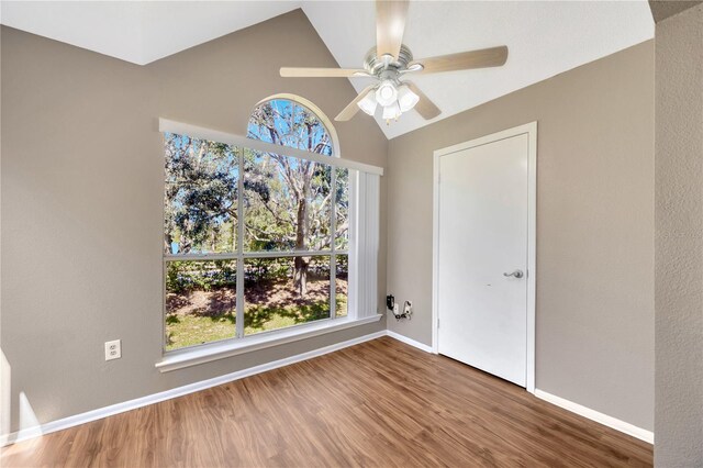 unfurnished room featuring ceiling fan, hardwood / wood-style flooring, and lofted ceiling