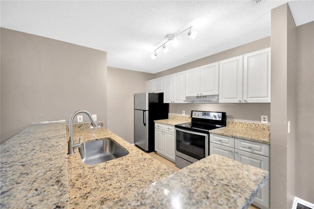 kitchen featuring white cabinetry, light stone countertops, stainless steel appliances, and sink