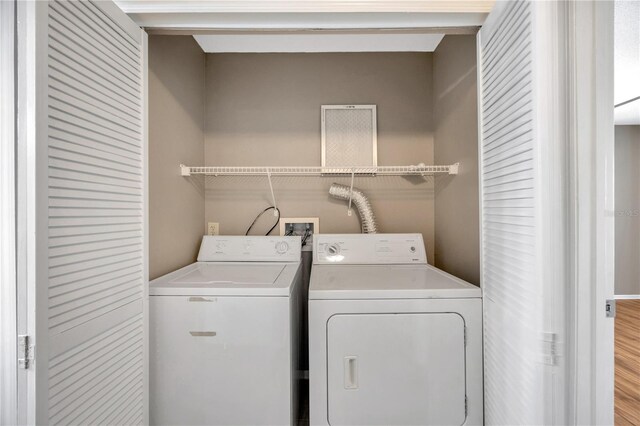 washroom featuring independent washer and dryer and light wood-type flooring