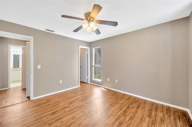 unfurnished room featuring ceiling fan and light wood-type flooring