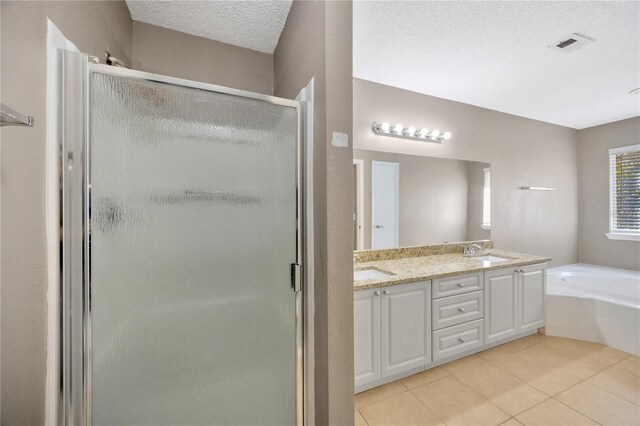 bathroom with vanity, tile patterned floors, a textured ceiling, and separate shower and tub