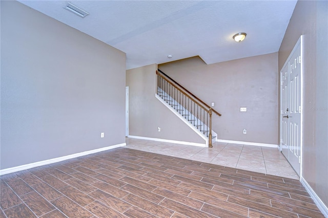 interior space featuring baseboards, stairway, and wood tiled floor