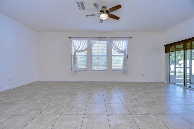 unfurnished room featuring light tile patterned floors, baseboards, visible vents, and ceiling fan