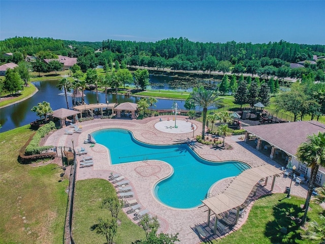 pool featuring a water view, a patio, and fence