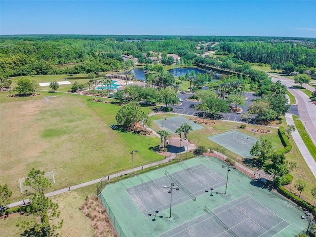 birds eye view of property with a forest view and a water view